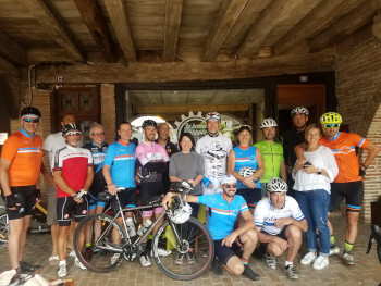A group of cyclists pose for a photograph outside La Bonne Echappée.