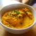 Carrot hummus garnished with chives or coriander.